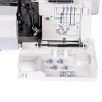 Close-up of a sewing machine with a chart on the needle area
