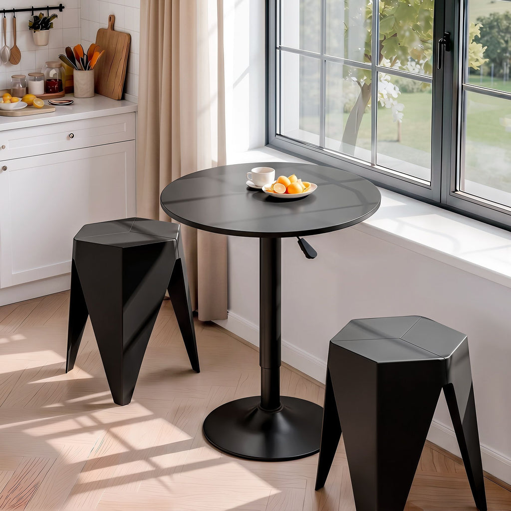 Black round table with two stools in a kitchen setting