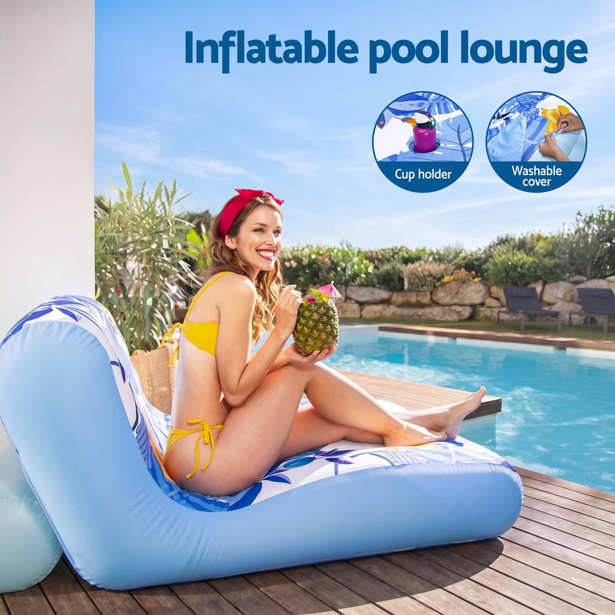 A woman in a yellow bikini lounges on a light blue inflatable pool lounger by a swimming pool. The lounger has a blue and white patterned design and includes a cup holder.
