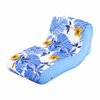 An inflatable lounge chair with a blue and white tropical leaf and flower print, featuring a solid light blue side bolster, shown on a plain white background.