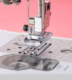 Sewing machine needle and presser foot on a pink background