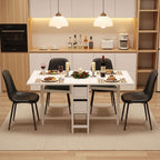Dining area with a table set for a meal, surrounded by chairs in a modern kitchen.