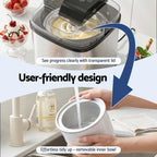 Kitchen appliance with transparent lid and removable inner bowl, shown in use.