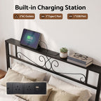 A built-in charging station shown installed in a bed headboard, featuring a black metal frame with an integrated power outlet, AC outlets, a Type-C port, and a USB port. A tablet is charging on the shelf above, with a small plant and books on the bed.