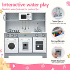 A children's toy kitchen playset with a white and gray stove, sink, microwave, and hanging utensils, shown on a pink-and-white promotional background with callout circles highlighting features like the swivel faucet, removable sink, and water dispenser.