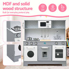 A children's MDF play kitchen set shown in a staged room scene with promotional text and feature icons. The kitchen has a gray wood-grain frame, white cabinets and countertops, toy stovetops with pots and pans, hanging utensils, a sink, and toy appliances.