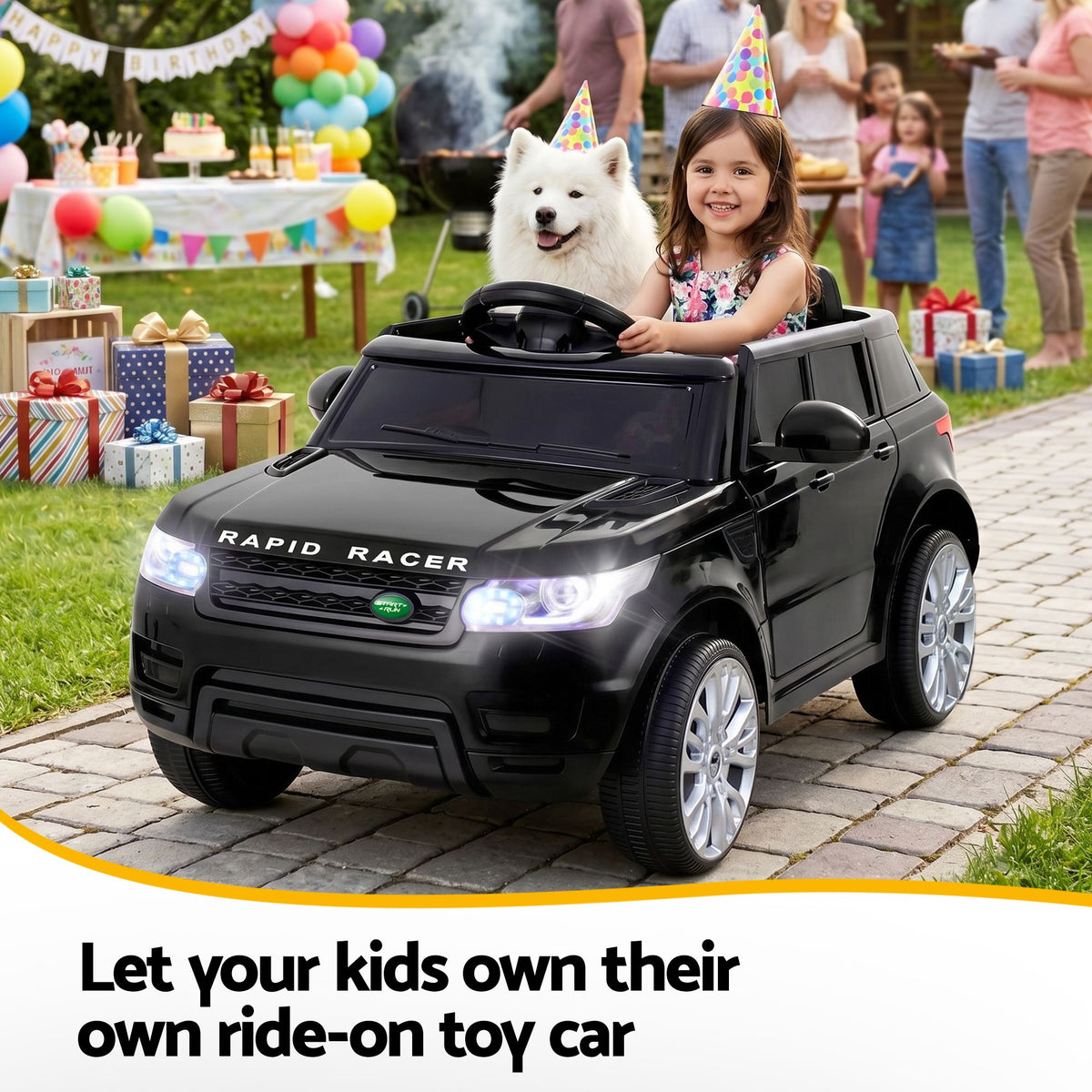 Child in a toy car with a dog, surrounded by party decorations and people in an outdoor setting.