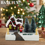 Christmas-themed miniature scene with a house, Santa Claus, and trees on a wooden surface.