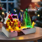 Christmas-themed miniature village scene with lights on a table.