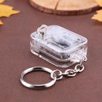 Clear mechanical keychain on a brown surface with leaves
