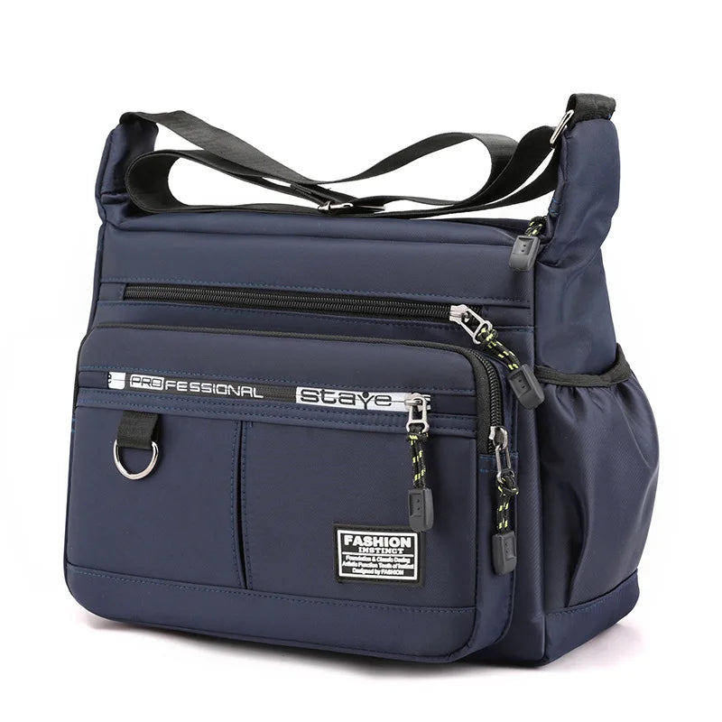 Navy blue handbag with multiple zippers on a white background