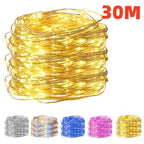 A large coiled bundle of warm white fairy string lights on a white background, with a red '30M' text overlay and four smaller color variant thumbnails along the bottom showing silver, iridescent, blue, and pink options.