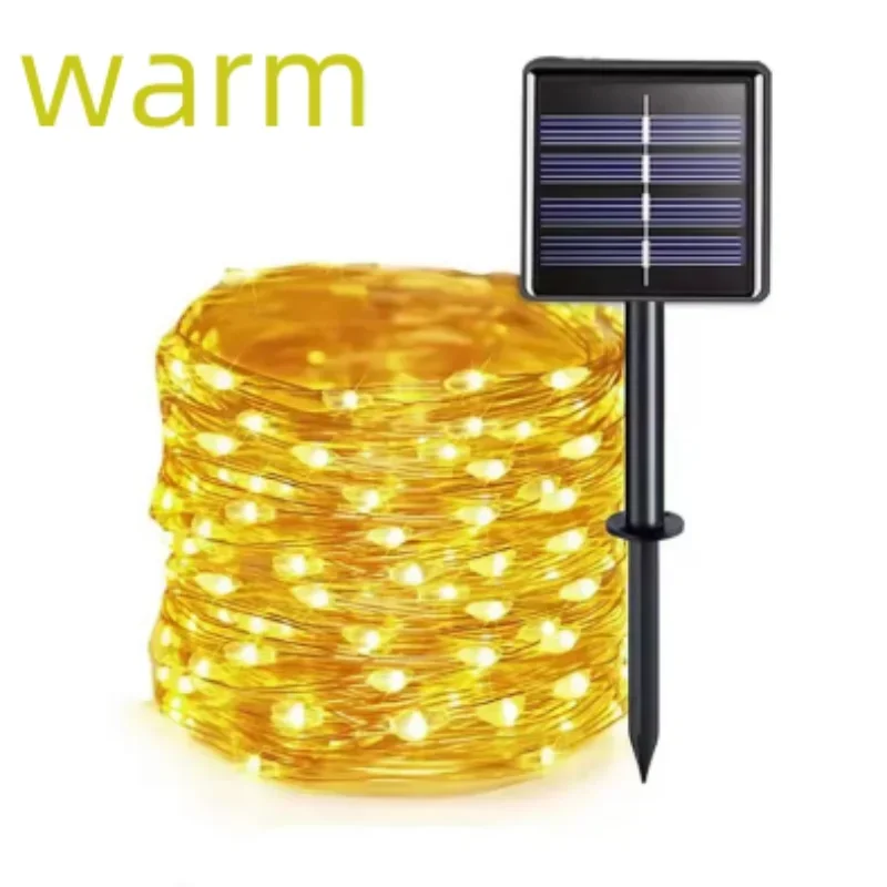 Warm white solar garden string lights coiled in a roll with a black solar panel stake, shown on a white background with the word 'warm' in yellow text.