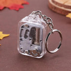 Clear mechanical keychain on a brown surface with autumn leaves