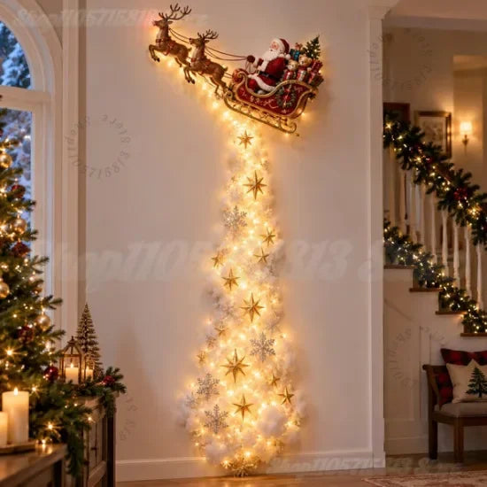 A festive Christmas wall decoration featuring Santa Claus in a sleigh pulled by reindeer, with a long cascading tree of warm white fairy lights and gold and silver star/snowflake ornaments, displayed in a decorated indoor hallway.