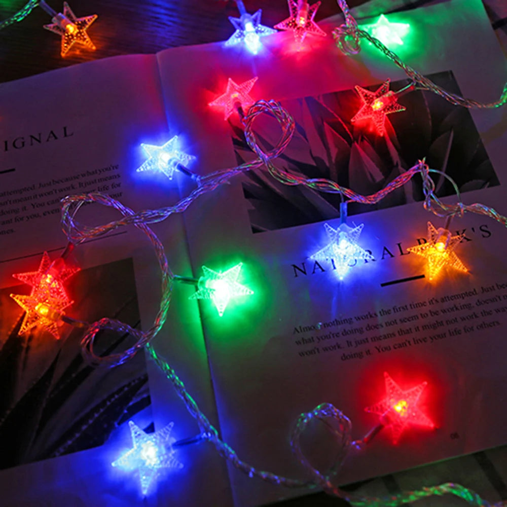 String of colorful star-shaped LED lights on an open book