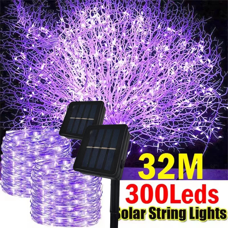 Purple solar string lights with two solar panels and wire coils, shown with text reading '32M 300Leds Solar String Lights' on a dark background.