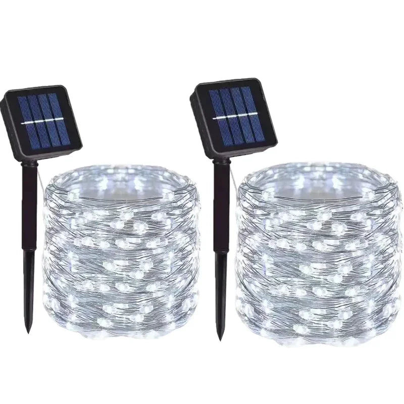 wo solar-powered string lights with small solar panels on a white background