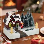Decorative Christmas scene with a house, trees, and Santa Claus on a wooden table.