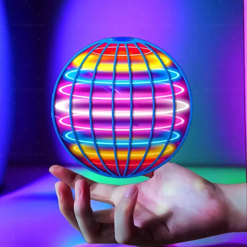 Colorful spherical light toy held in a hand with a vibrant purple background