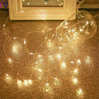 String lights on a gold glittery surface with a blurred background