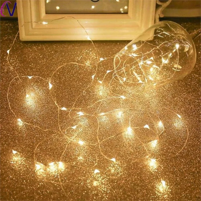 String lights on a gold glittery surface with a blurred background