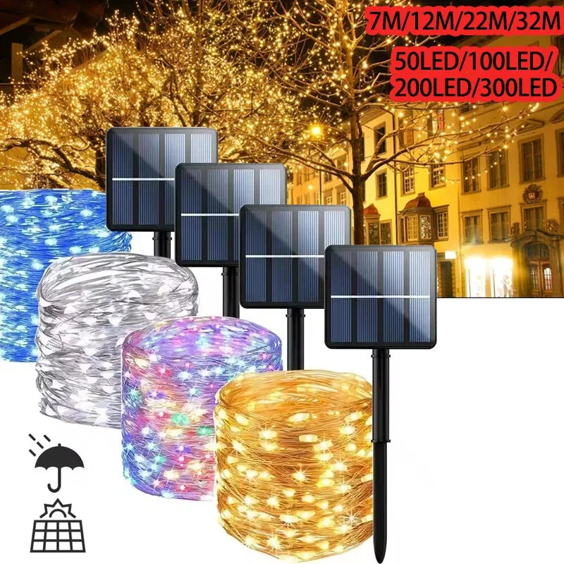 Solar string lights shown with four black solar panels and four wire rolls in blue, clear/white, purple, and warm white/gold. The background is a nighttime city street with lit trees and buildings, plus text indicating light counts from 7W to 300LED.