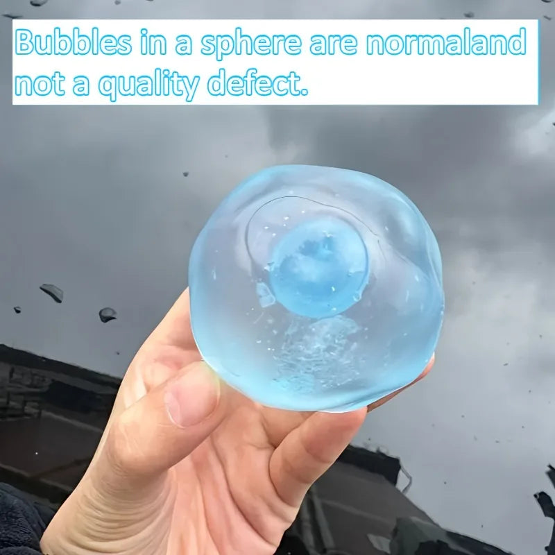 Blue sphere with bubbles held in a hand against a blurred background