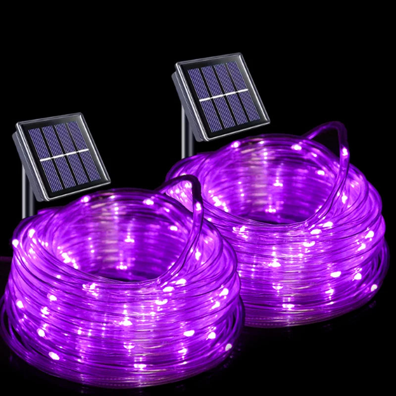 Two coiled rolls of purple solar-powered LED rope lights with small rectangular solar panels attached, shown on a black background.
