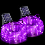 Two coiled rolls of purple solar-powered LED rope lights with small rectangular solar panels attached, shown on a black background.