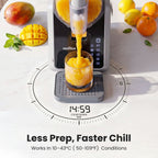 Norda juice maker dispensing orange juice into a glass with mangoes and lemons on a white background.