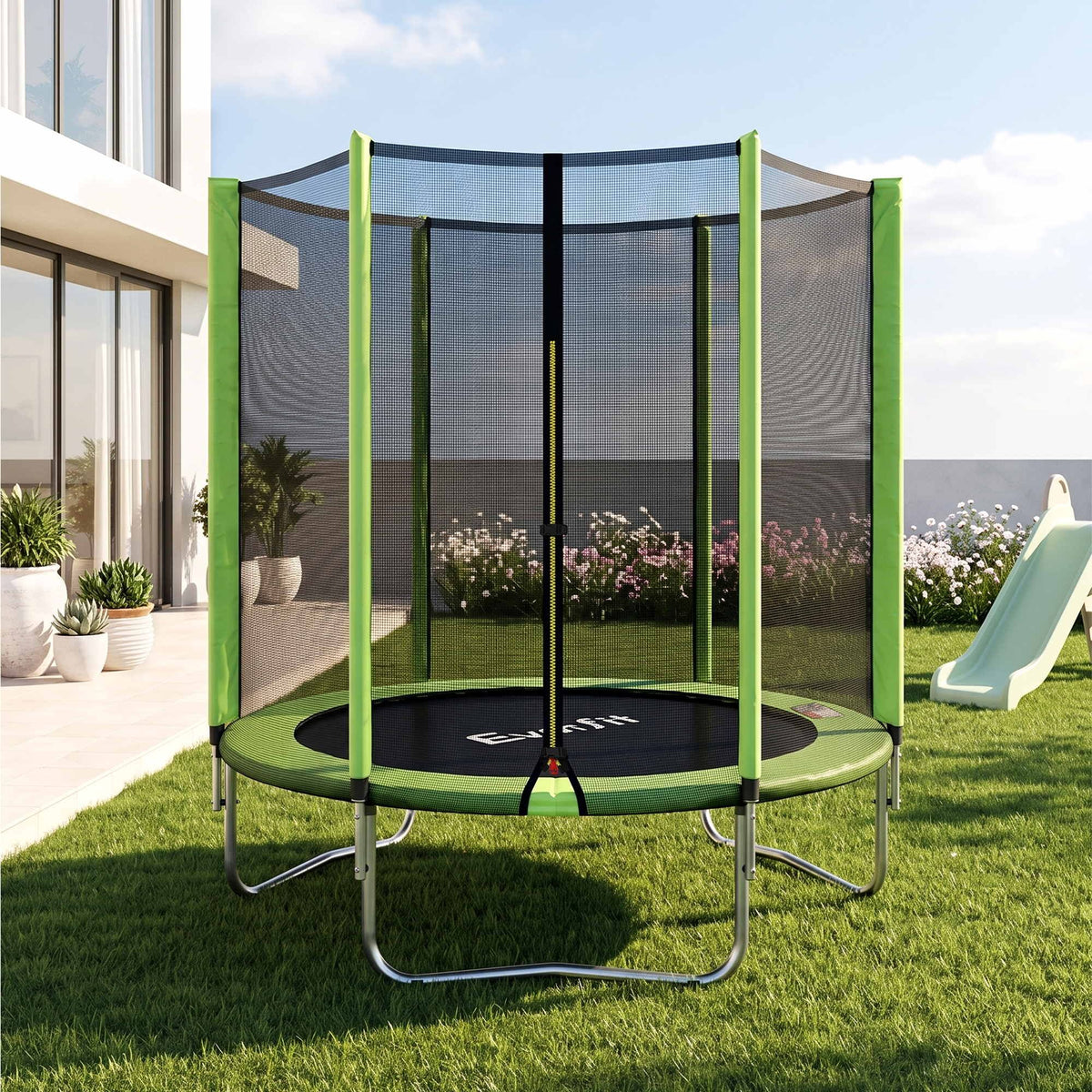 A round trampoline with a green safety net enclosure and silver metal legs, set on a grassy backyard lawn next to a house with a slide nearby.

Details