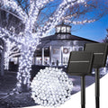 Solar string lights on trees with a gazebo in the background