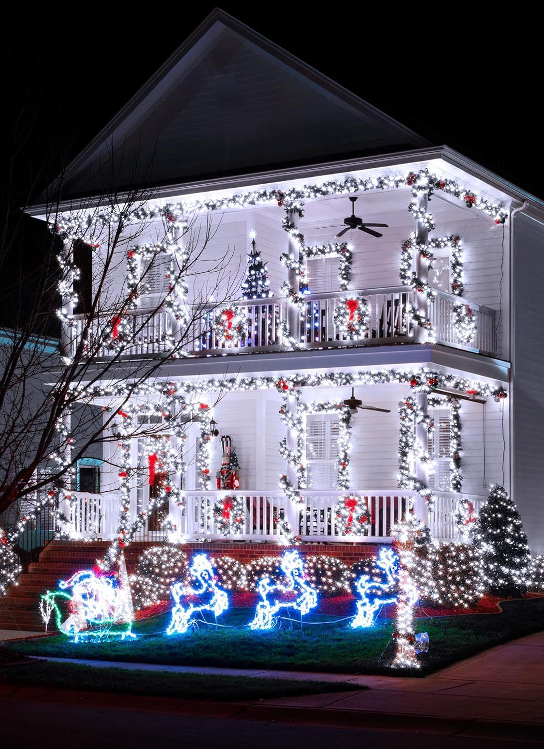 House decorated with Christmas lights and ornaments at night