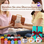 Two women holding a brown bag with a decorative item, surrounded by colorful yarn and small stuffed toys on a table.