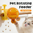 A cat interacting with a yellow and orange pet rotating feeder mounted on a wall, with text reading 'Pet Rotating Feeder' and '360° Rotation'.