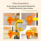 An orange translucent suction cup mounting accessory shown in multiple usage examples on a beige background, with text reading 'Play Anywhere' and labels for square table leg, door edge, stair railing, and table edges