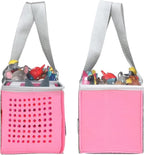 Pink hanging storage bins with toys inside on a white background