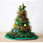 Decorative Christmas tree with tinsel, ornaments, and a star on a white background