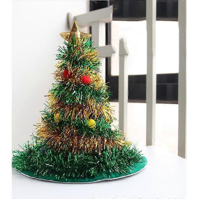 Small decorative Christmas tree with gold star and red ornaments on a white surface.