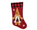 Red Christmas stocking with a gnome design on a white background