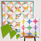 Colorful quilt and pillow with geometric patterns on a white background