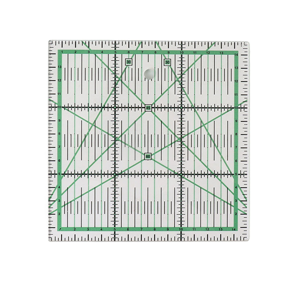 A square clear acrylic quilting ruler with green grid lines, black measurement markings, and diagonal crosshairs on a white background.