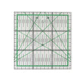 A square clear acrylic quilting ruler with green grid lines, black measurement markings, and diagonal crosshairs on a white background.