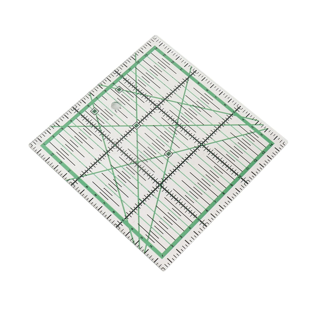 A clear acrylic quilting ruler with green and black measurement markings, shown rotated on a plain white background.