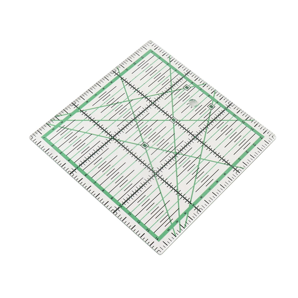A clear acrylic quilting ruler with green and black measurement markings, shown at an angle on a plain white background.