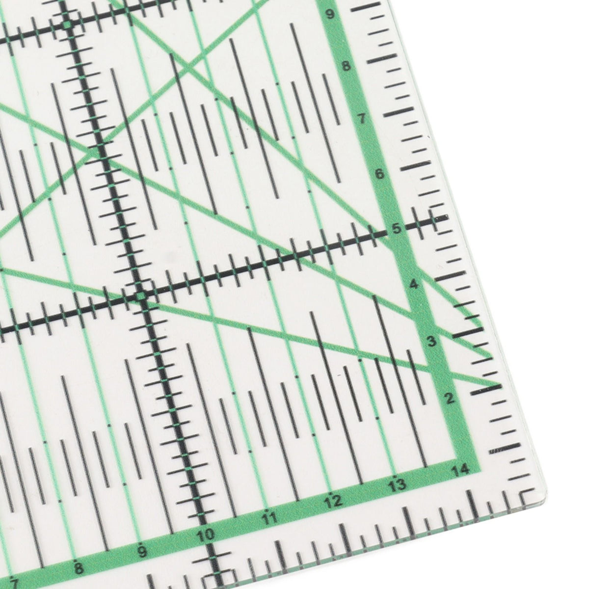 Close-up of a clear acrylic quilting ruler with green and black measurement markings, showing a 14-inch square corner on a white background.