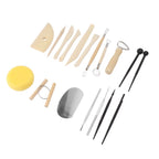 A pottery wheel throwing tool set arranged on a white background, including wooden sculpting knives and scrapers, metal tools, a yellow sponge, a gray wheel blank, and two black sticks.