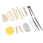 A pottery and clay sculpting tool set arranged on a white background, including wooden and metal spatulas, sculpting knives, a yellow sponge, a metal wheel roller, and other hand tools.