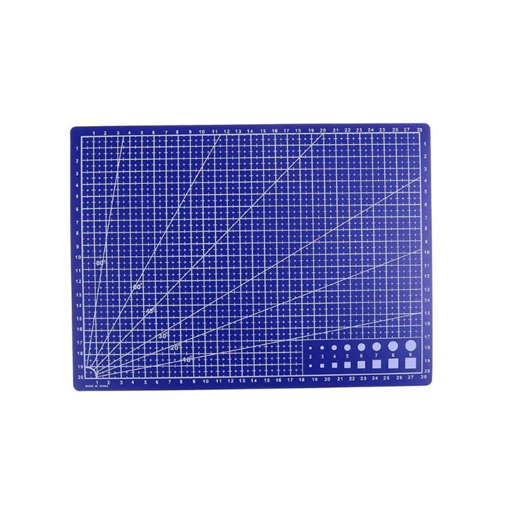 A blue self-cleaning cutting mat with white grid lines, angle guides, and a small set of circular and square cutters in the bottom right corner, shown on a plain white background